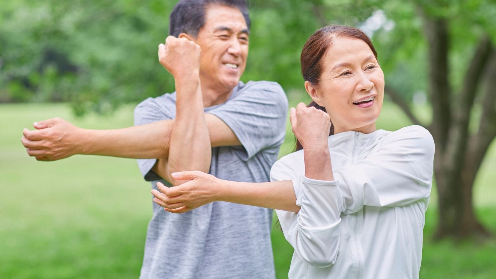 Two people stretching outdoors
