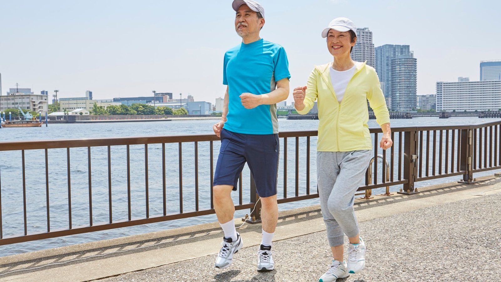 Two people jogging outdoors by the water