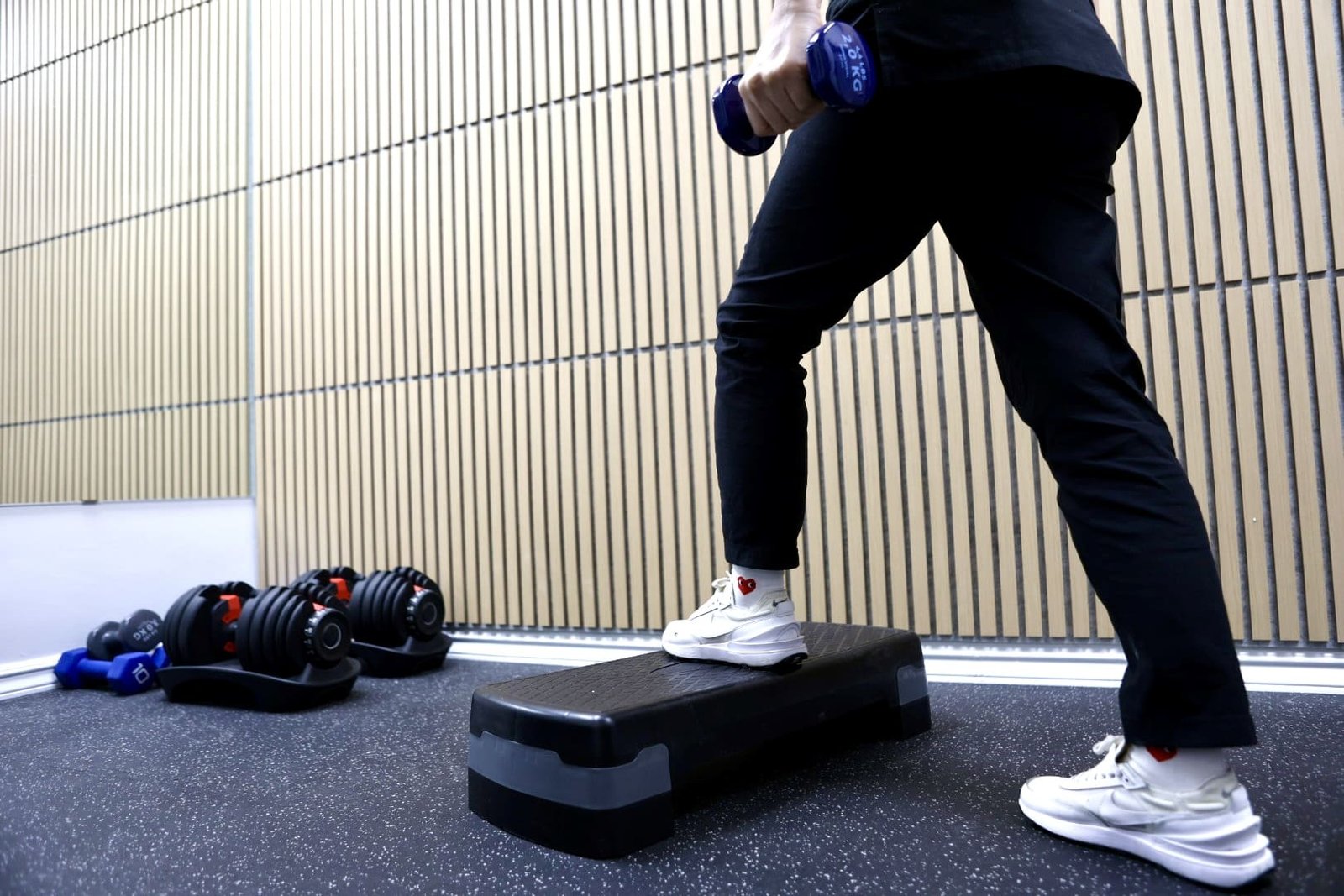 Kinesiologist guiding a dumbbell step-up exercise at Indigo Wellness Clinic, Coquitlam